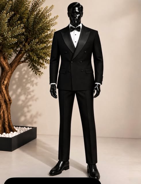 Black double-breasted tuxedo with bow tie on a mannequin