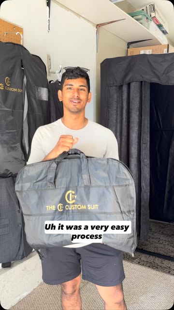 Customer holding a City Custom Suits garment bag, captioned 'It was a very easy process'